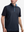 Front upper body shot of model wearing navy flower  full print quarter zip sleeveless vest pullover