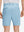 Back lower body shot of model wearing sky blue flat front flex cotton blend golf shorts