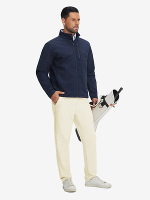 Model carrying a tennis bag, wearing beige lightweight flat front casual trousers in full-body view.