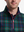 Close-up front view from nose to chest of model wearing dark plaid  full print quarter zip sleeveless vest pullover