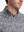 Close-up front view from nose to chest of model wearing grey/wine camo full print quarter zip sleeveless vest pullover