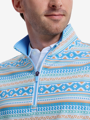 Close-up front view from nose to chest of model wearing blue ethnic  full print quarter zip sleeveless vest pullover