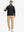 Model holding golf club wearing lightweight water-resistant outerwear jacket, active black style