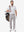 Front full body shot of model wearing white  ultra-comfort slim fit roma knit polo shirts with golf bag on back