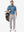 Front full body shot of model wearing light  blue  ultra-comfort slim fit roma knit polo shirts with golf bag on back