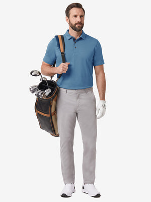 Front full body shot of model wearing light  blue  ultra-comfort slim fit roma knit polo shirts with golf bag on back