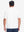 Back upper body shot of model wearing white dry fit waffle textured collared golf shirts
