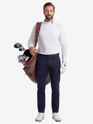 Front full body shot of model wearing white warm brushed mock neck golf t shirt with golf bag on back