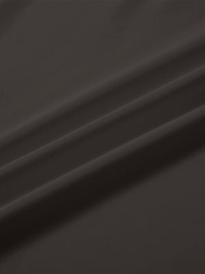 Close-up texture of  dark brown solid stretch cotton pique long sleeve polo shirts fabric showing detailed premium material and weave.