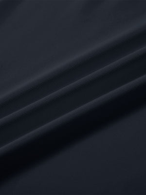 Close-up texture of  dark navy solid stretch cotton pique long sleeve polo shirts fabric showing detailed premium material and weave.