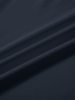 Close-up texture of  navy solid stretch cotton pique long sleeve polo shirts fabric showing detailed premium material and weave.
