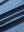 Close-up of blue denim stripe performance cooling polo - youth fabric texture.