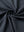 Close-up of dark grey premium performance polo fabric showing smooth texture.