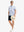 Full-body front view holding a takeaway drink cup, wearing WHITE COMPASS MAP Stylish Printing Summer Shirt.